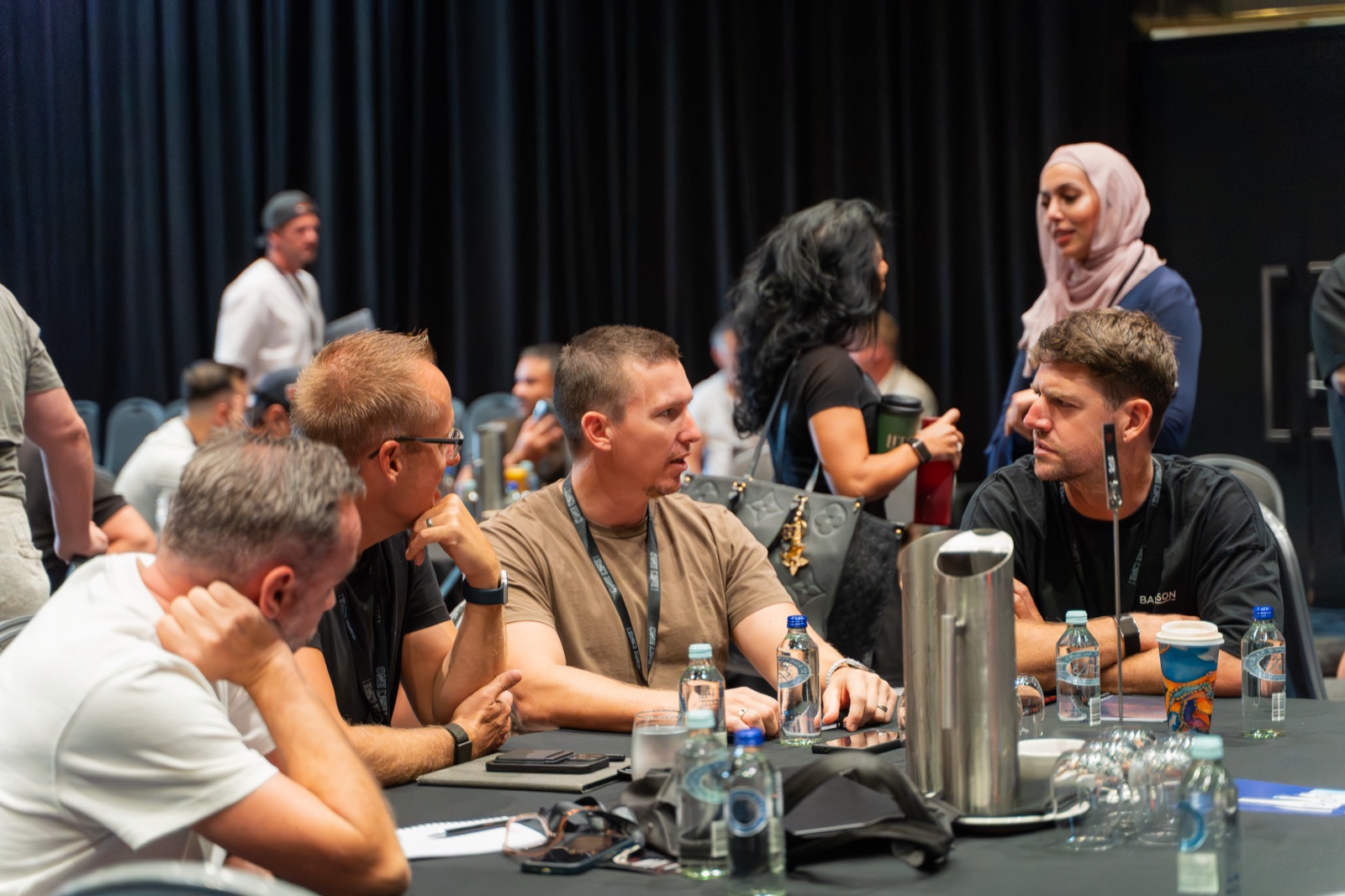 Members in conversation around a One Life Club summit table